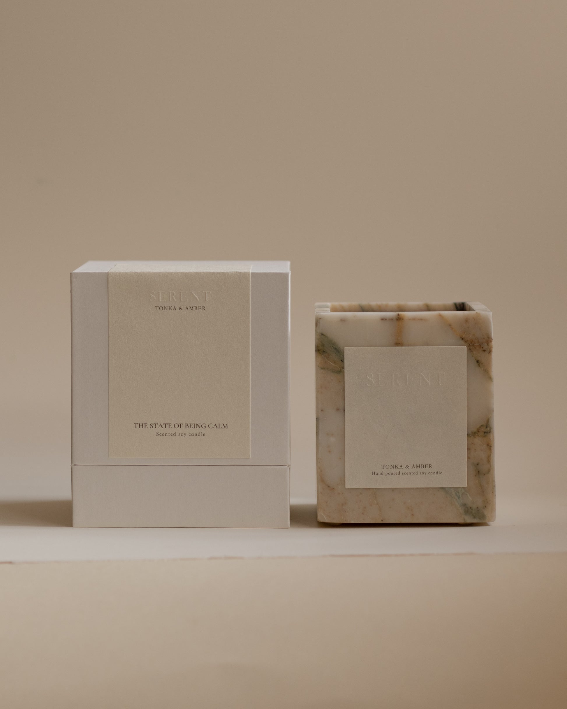 Tonka & Amber luxury scented candle by Sérent in natural marble container.
